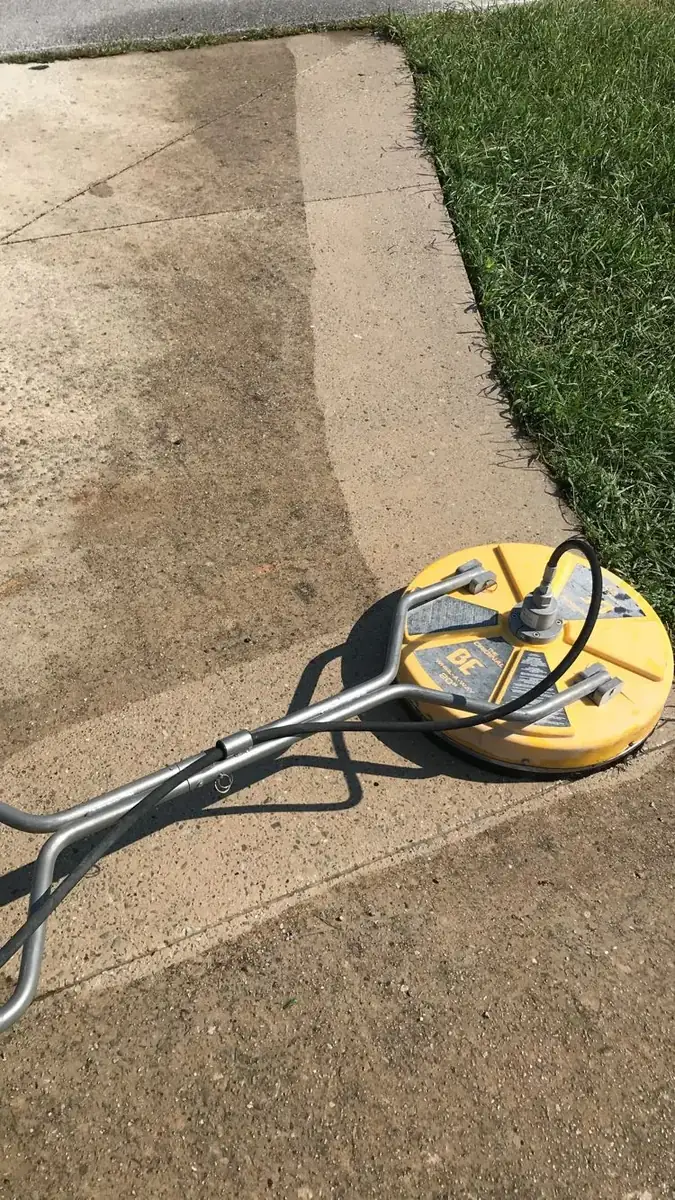 Surface cleaner machine washing a concrete driveway